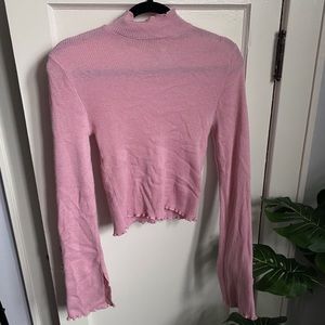 Pink turtleneck sweater with frill detail